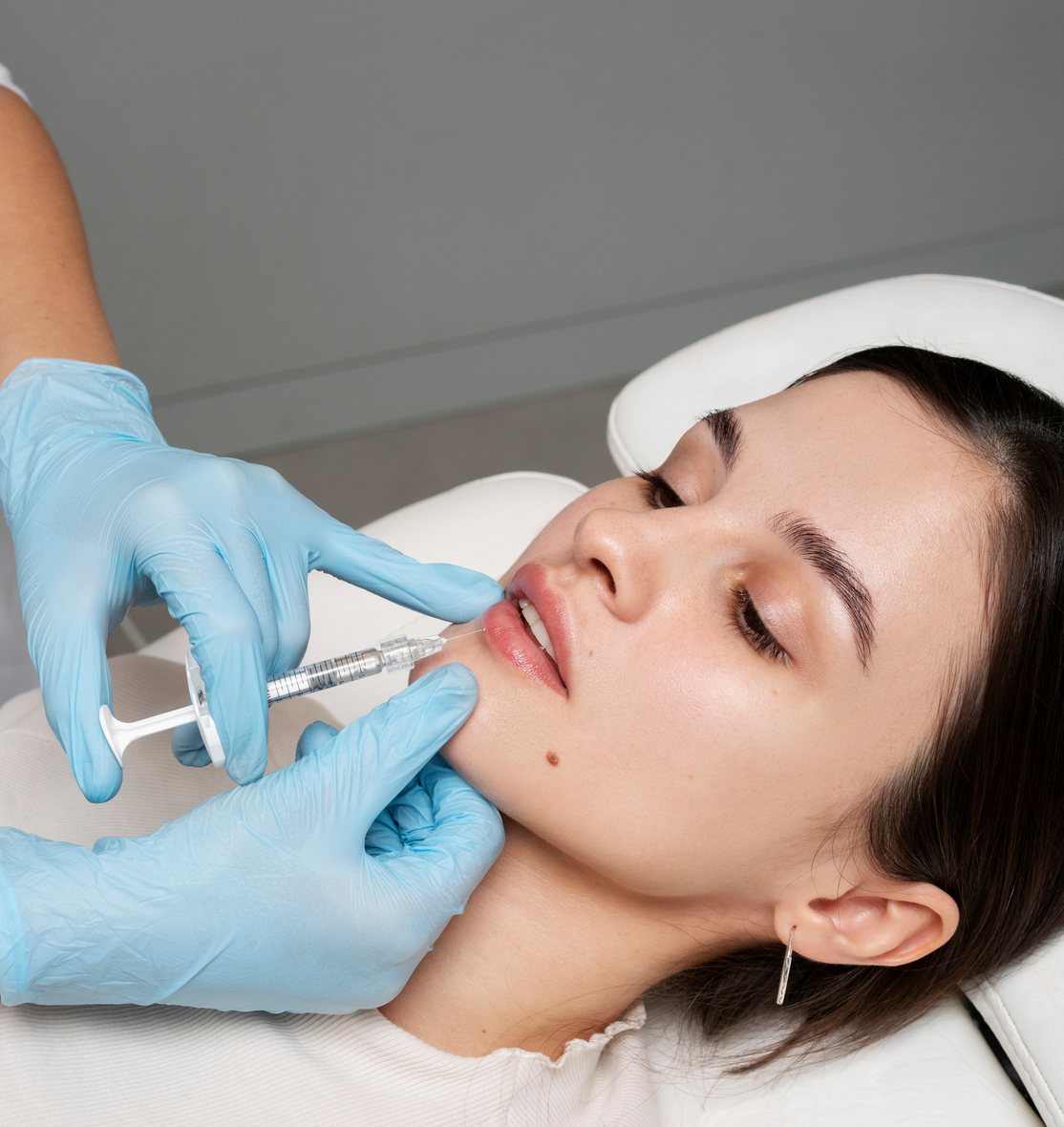 Woman receiving a lip injection treatment