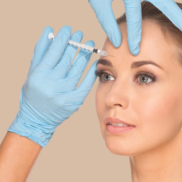 Woman receiving a Botox injection between the brows